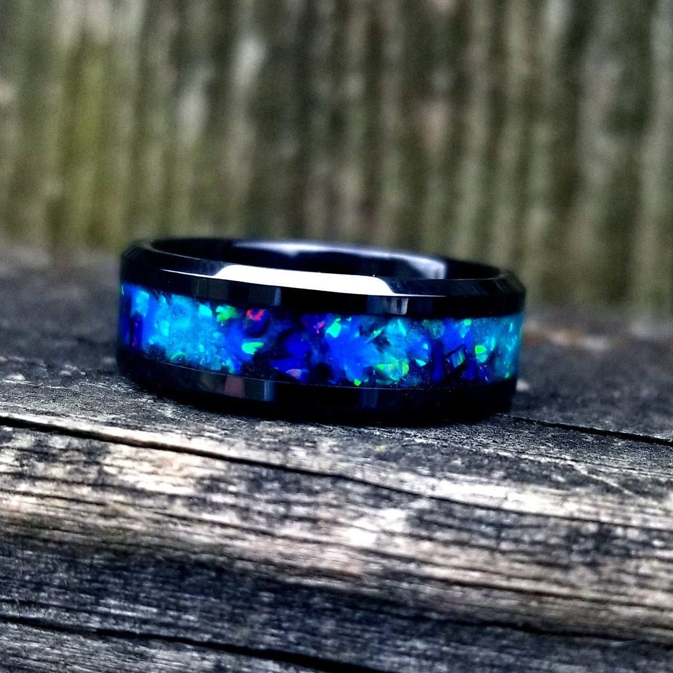 Black ceramic galaxy glow ring with turquoise opal and blue fire